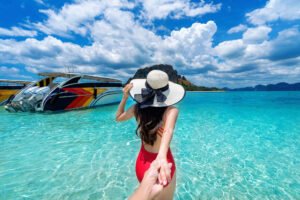bikini girl holding man s hand leading him ocean krabi thailand